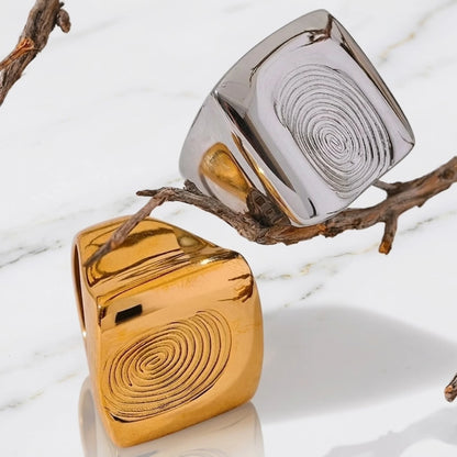 BEHI MILANO Fingerprint Ring — gold and silver fingerprint statement rings close-up on marble surface