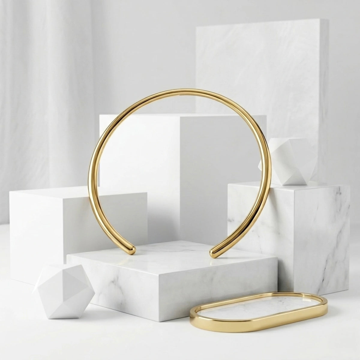 BEHI MILANO Flavia Choker — gold open collar necklace on geometric white display blocks