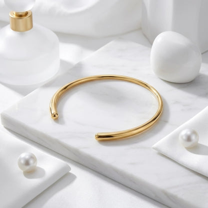 BEHI MILANO Flavia Choker — 18k gold open collar necklace styled on white marble platform