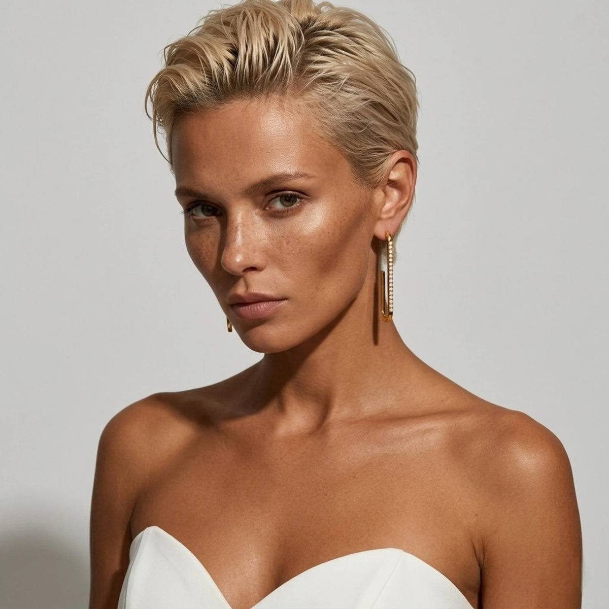 BEHI MILANO Floriana Earrings — blonde model portrait wearing gold pearl statement drop earrings