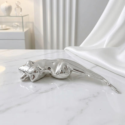 BEHI MILANO Galina Brooch — silver sculptural figure brooch displayed on white marble next to satin fabric