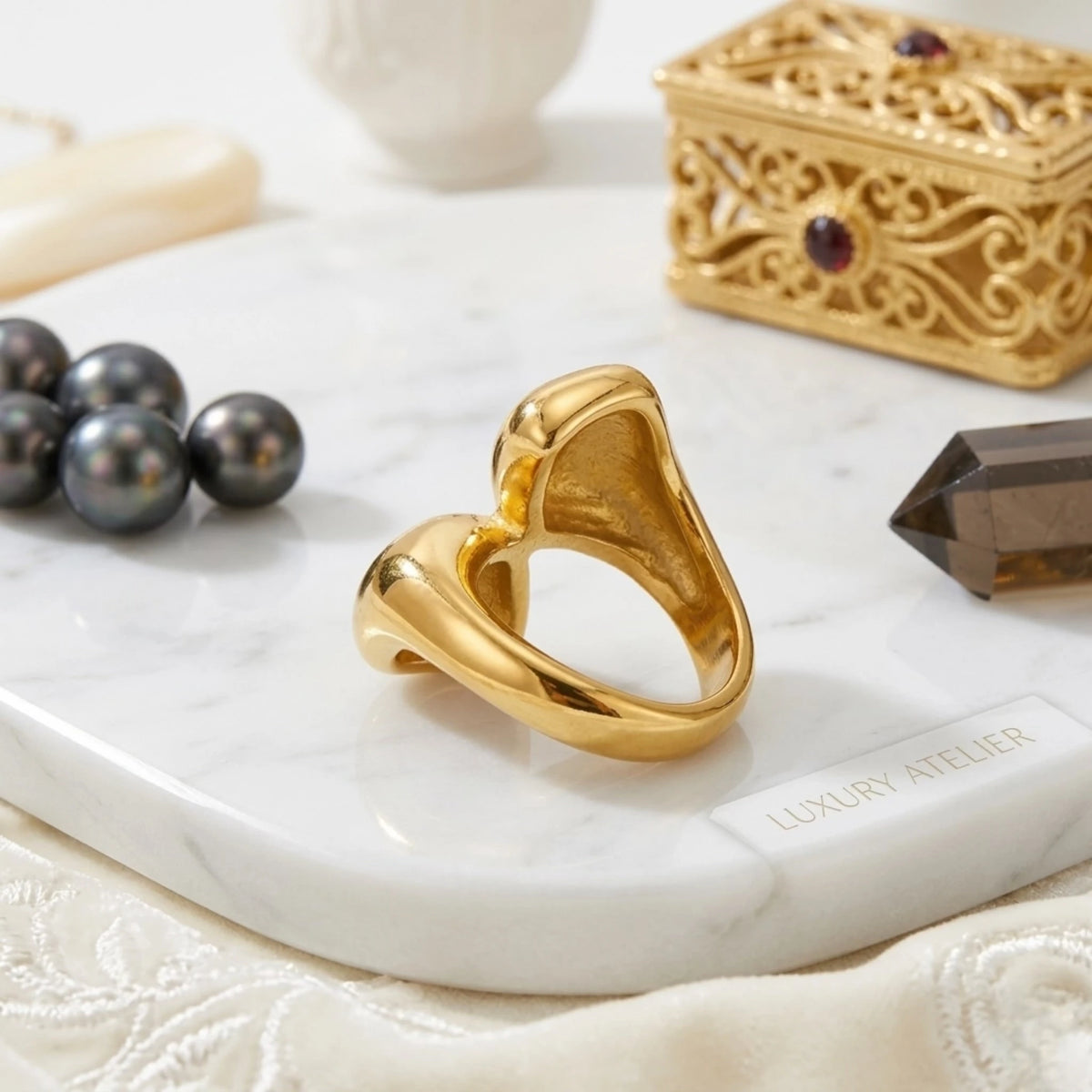 BEHI MILANO Garlita Ring — back angle view of gold open bypass ring band on marble