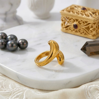 BEHI MILANO Garlita Ring — side profile view of gold statement ring on marble dish