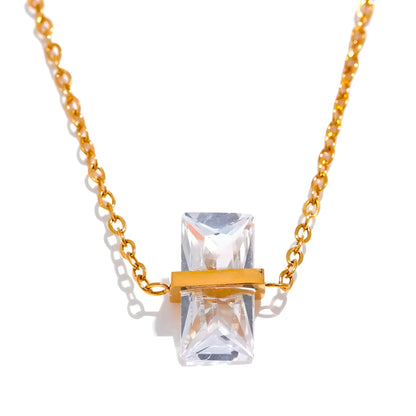 BEHI MILANO Glinka Necklace — clear crystal gemstone pendant necklace on marble next to luxury box