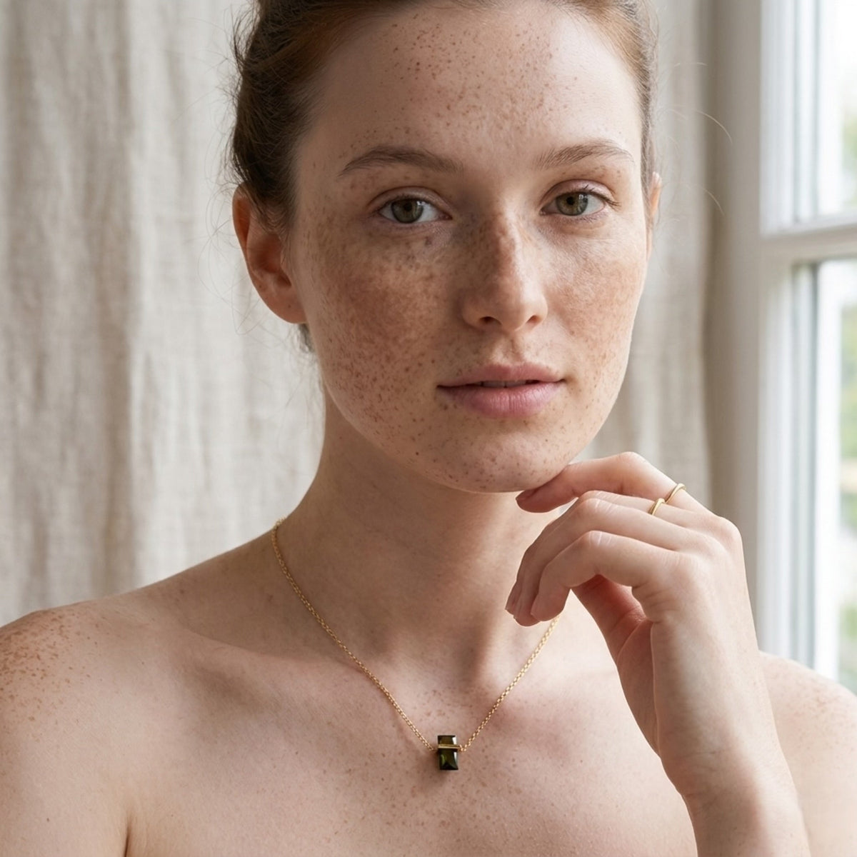 BEHI MILANO Glinka Necklace — redhead model wearing green gemstone pendant necklace