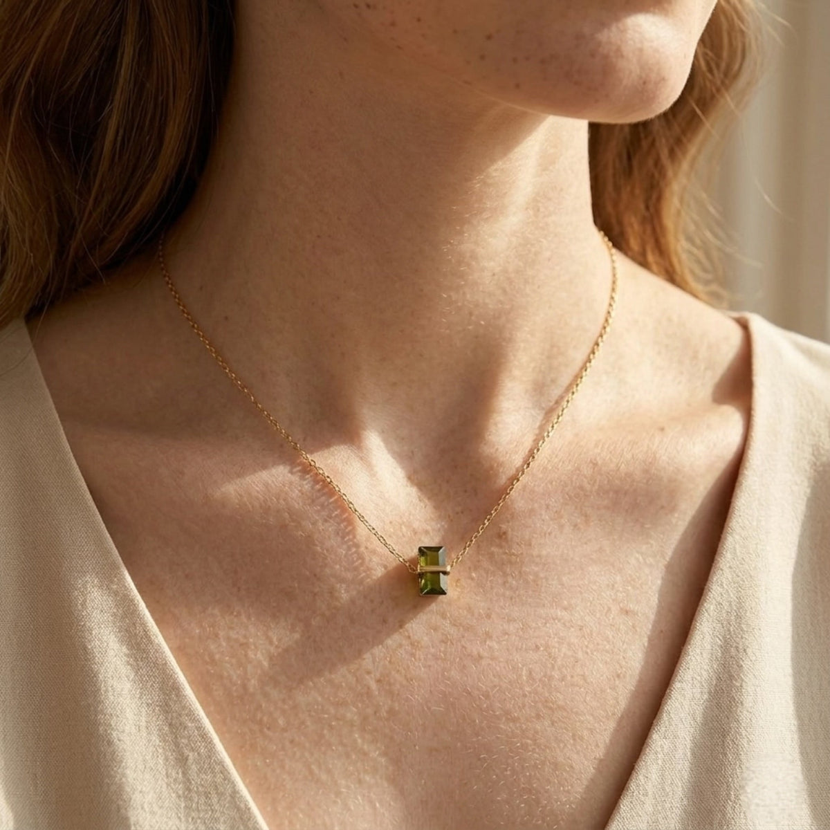 BEHI MILANO Glinka Necklace — neck close-up of model wearing gold green zircon pendant necklace