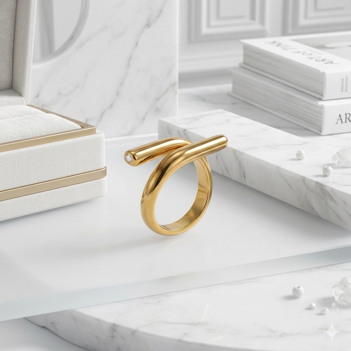 BEHI MILANO Greta Ring — 18k gold wrap ring on white tray in soft natural lighting