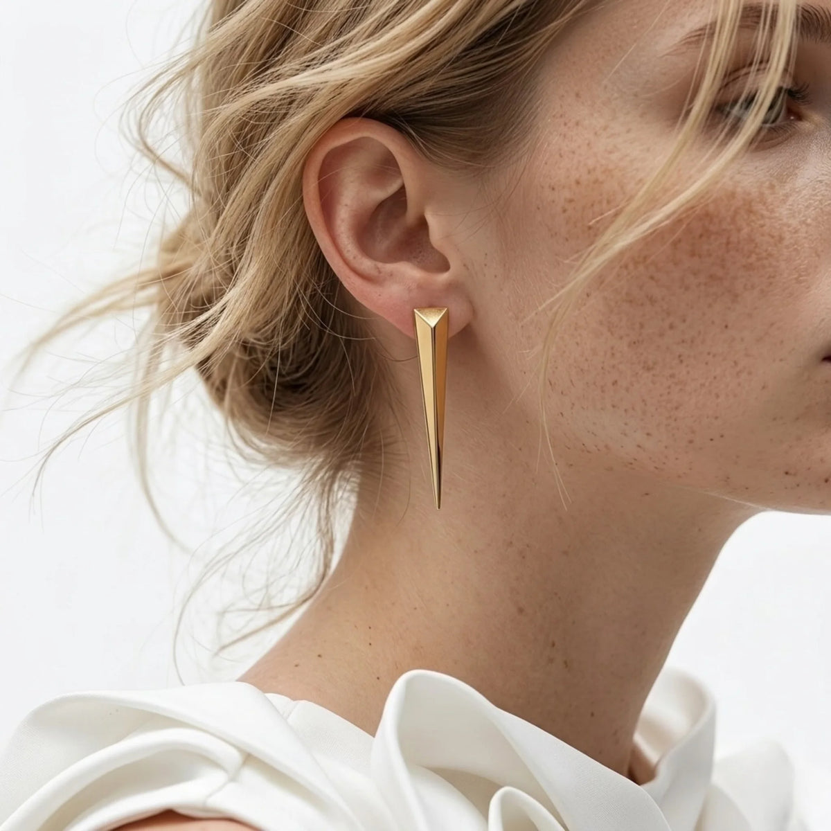BEHI MILANO Hanika Earrings — ear close-up of model wearing 18k gold tapered spike earring