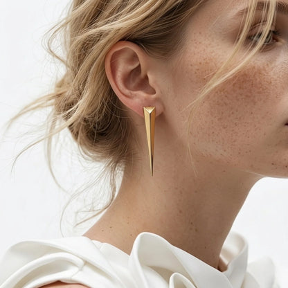 BEHI MILANO Hanika Earrings — ear close-up of model wearing 18k gold tapered spike earring