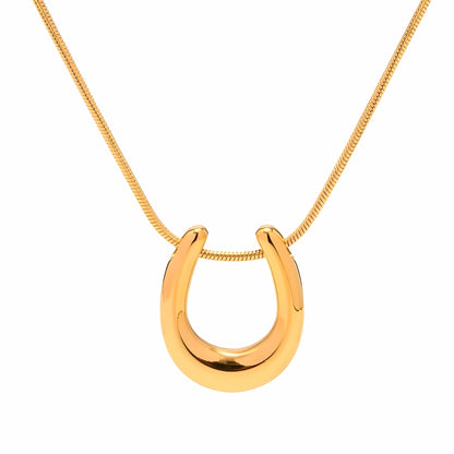 BEHI MILANO Horseshoe Necklace — 18k gold polished horseshoe pendant necklace on white background
