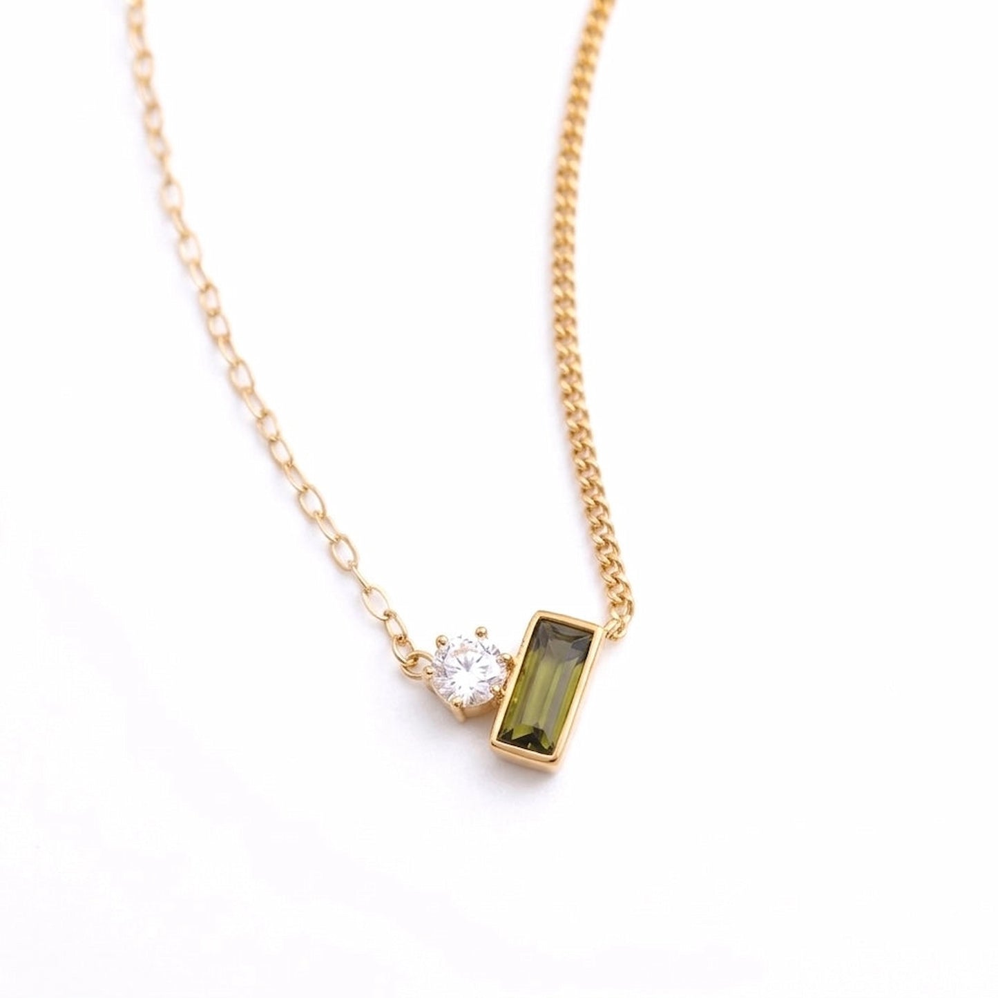 BEHI MILANO Ilona Necklace — 18k gold pendant necklace with clear and green zircon stones on white background