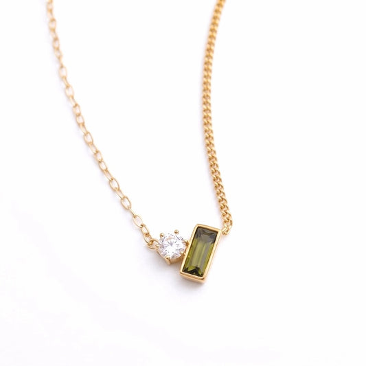 BEHI MILANO Ilona Necklace — 18k gold pendant necklace with clear and green zircon stones on white background