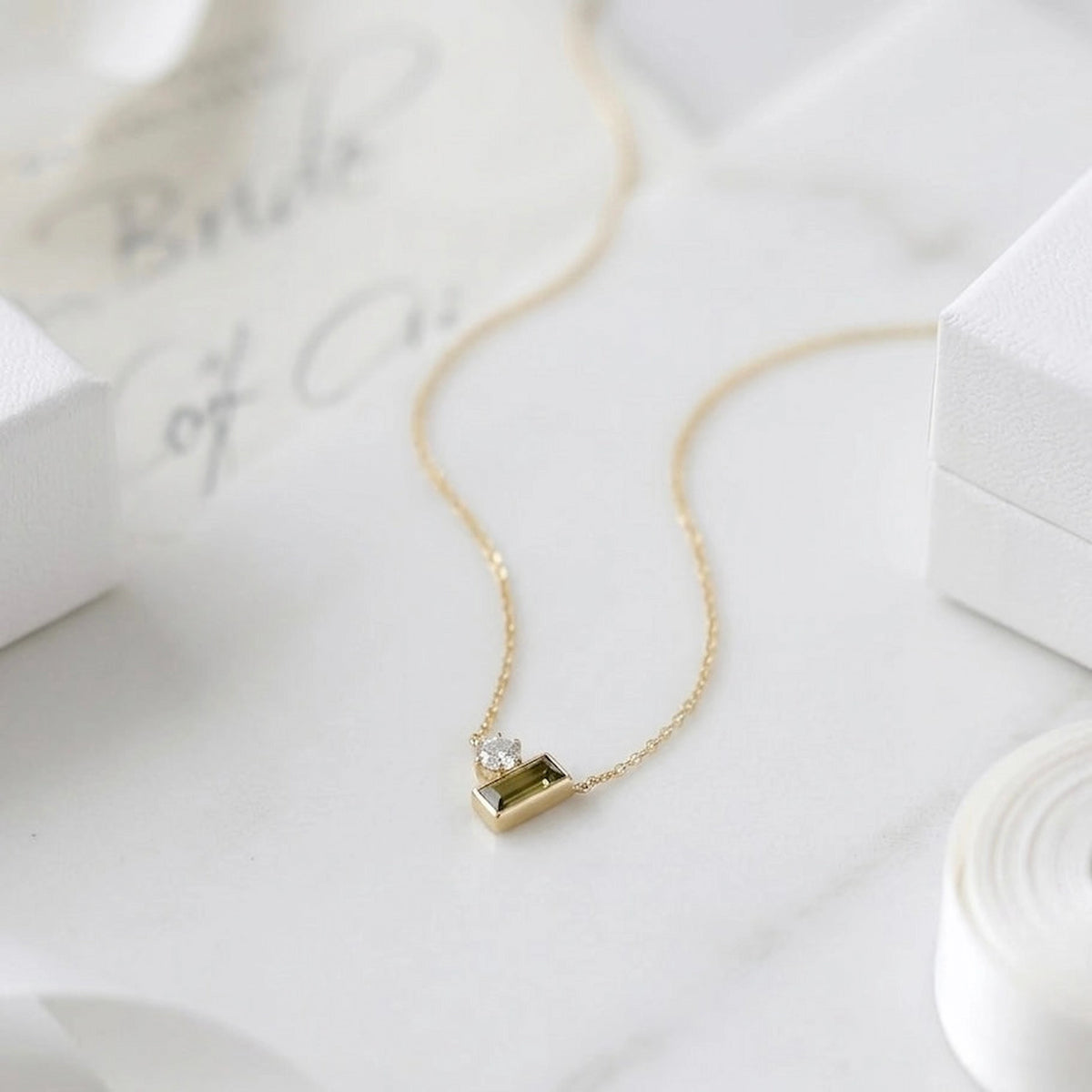 BEHI MILANO Ilona Necklace — close-up of emerald green and clear zircon pendant on fine gold chain