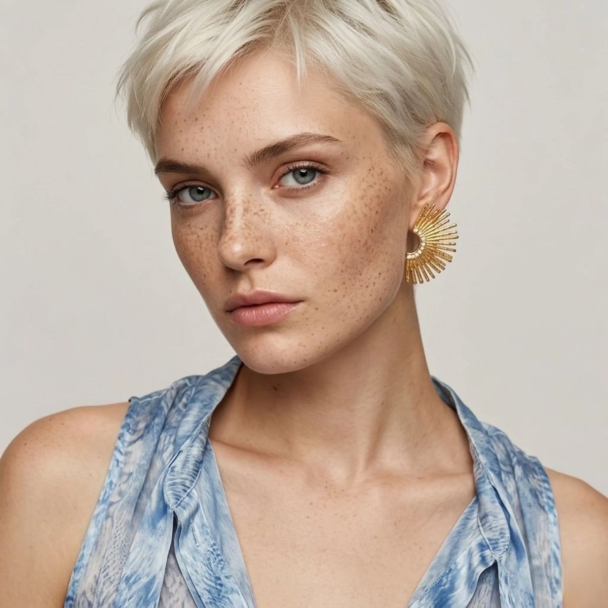 BEHI MILANO Indigamond Earrings — portrait of model wearing 18k gold textured fan statement studs