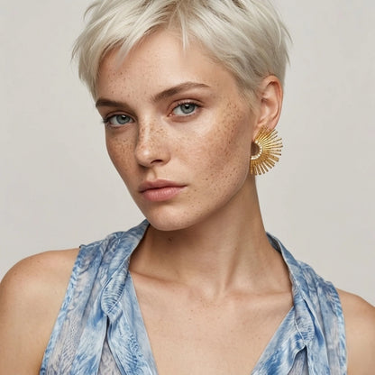BEHI MILANO Indigamond Earrings — portrait of model wearing 18k gold textured fan statement studs