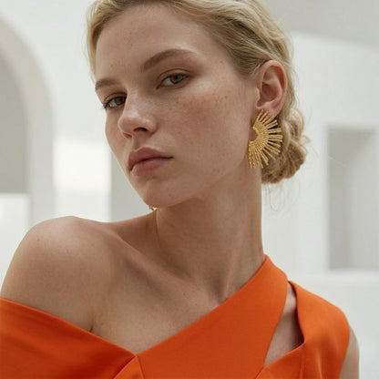 BEHI MILANO Indigo Earrings — portrait of model wearing 18k gold textured fan statement studs