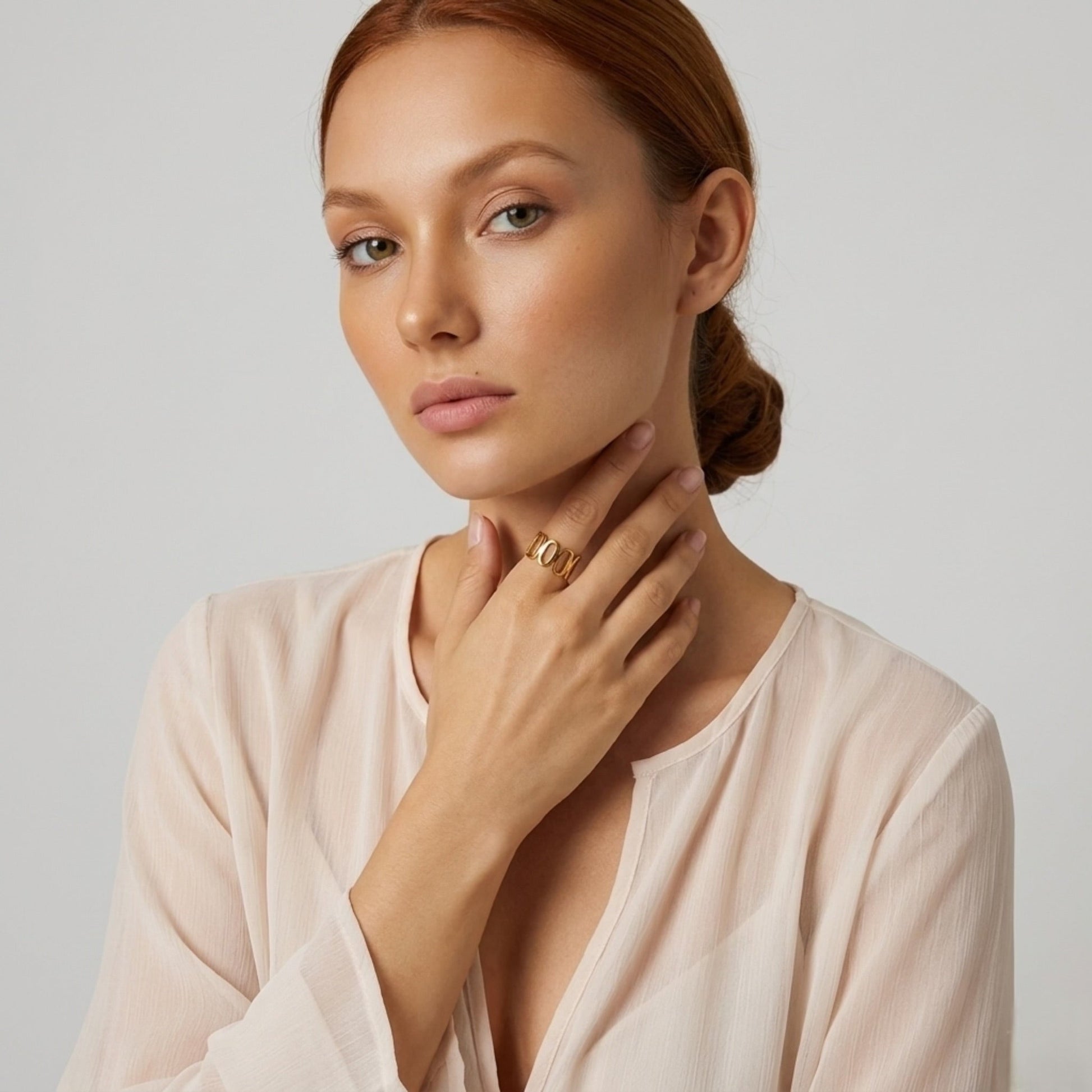 BEHI MILANO Indora Ring — portrait of model wearing gold adjustable statement ring in beige top