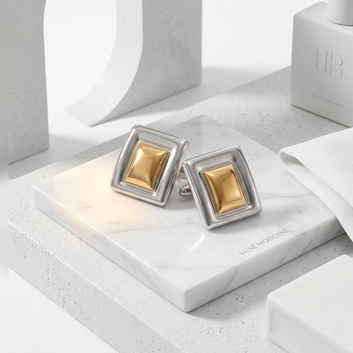 BEHI MILANO Isabella Earrings — two tone gold and silver studs on white geometric marble blocks