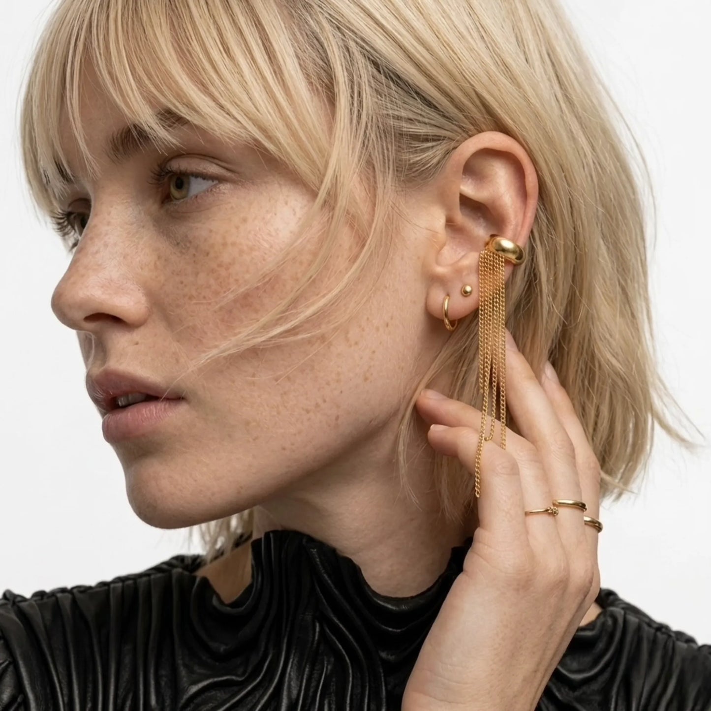 BEHI MILANO Iskra Ear Cuff — blonde model wearing single gold fringe ear cuff on cartilage