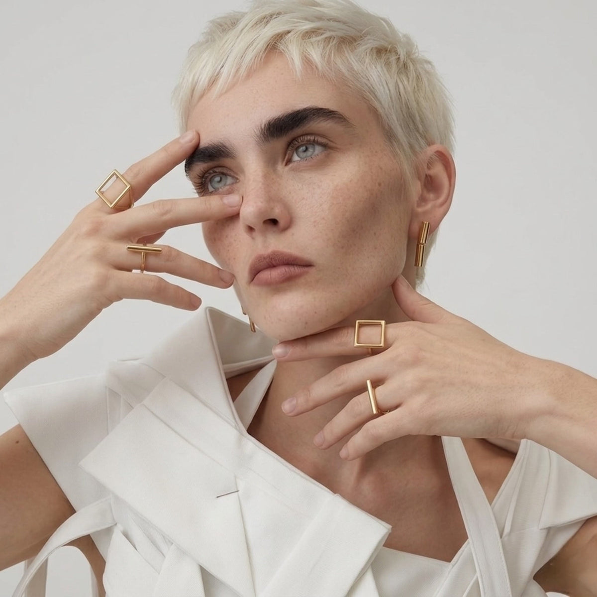 BEHI MILANO Ivana Earrings — close up portrait of model showcasing 18k gold geometric column earrings