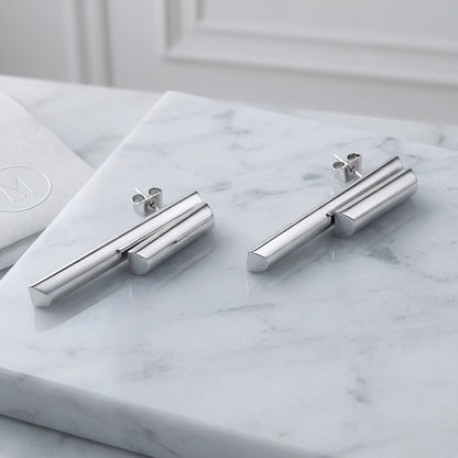BEHI MILANO Ivana Earrings — silver stainless steel architectural dual bar drop earrings on marble