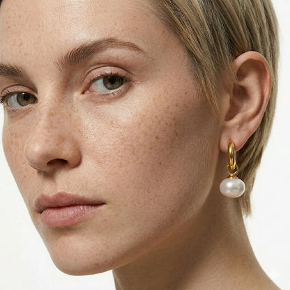 BEHI MILANO Jade Earrings — close up view of gold huggie hoop with white pearl drop on ear