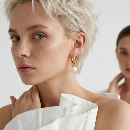 BEHI MILANO Jade Earrings — short blonde model wearing gold pearl drop earrings