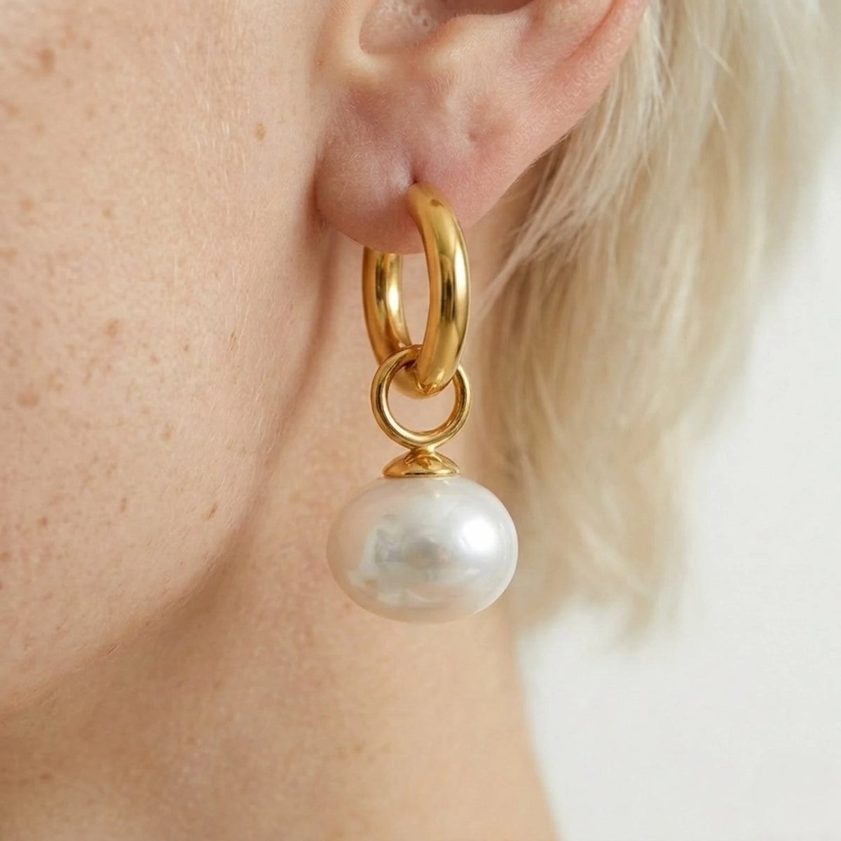 BEHI MILANO Jade Earrings — side angle view of gold pearl hoop earring on earlobe