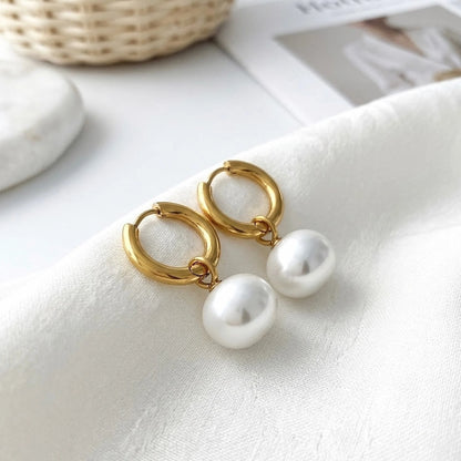 BEHI MILANO Jade Earrings — gold pearl drop hoops on white satin fabric with basket backdrop
