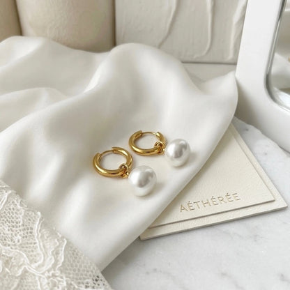BEHI MILANO Jade Earrings — pair of 18k gold pearl huggie hoops on white silk and lace