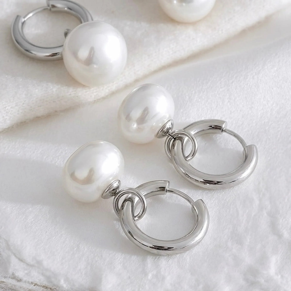 BEHI MILANO Jade Earrings — silver stainless steel pearl drop hoop earrings on white silk