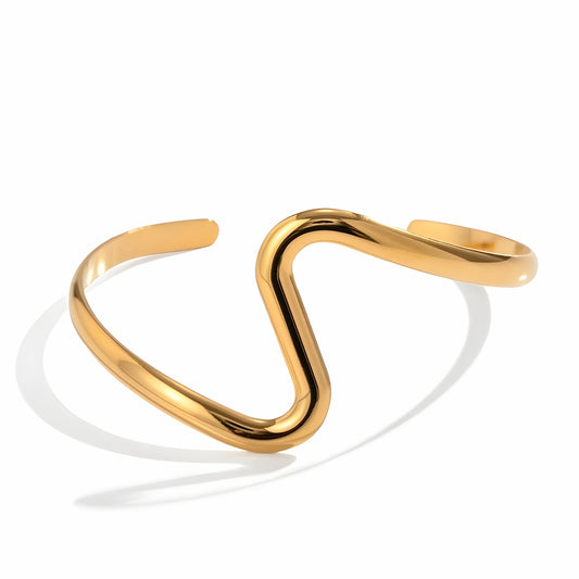BEHI MILANO Jojo Bracelet — 18k gold sculptural S-wave open cuff bracelet on white background