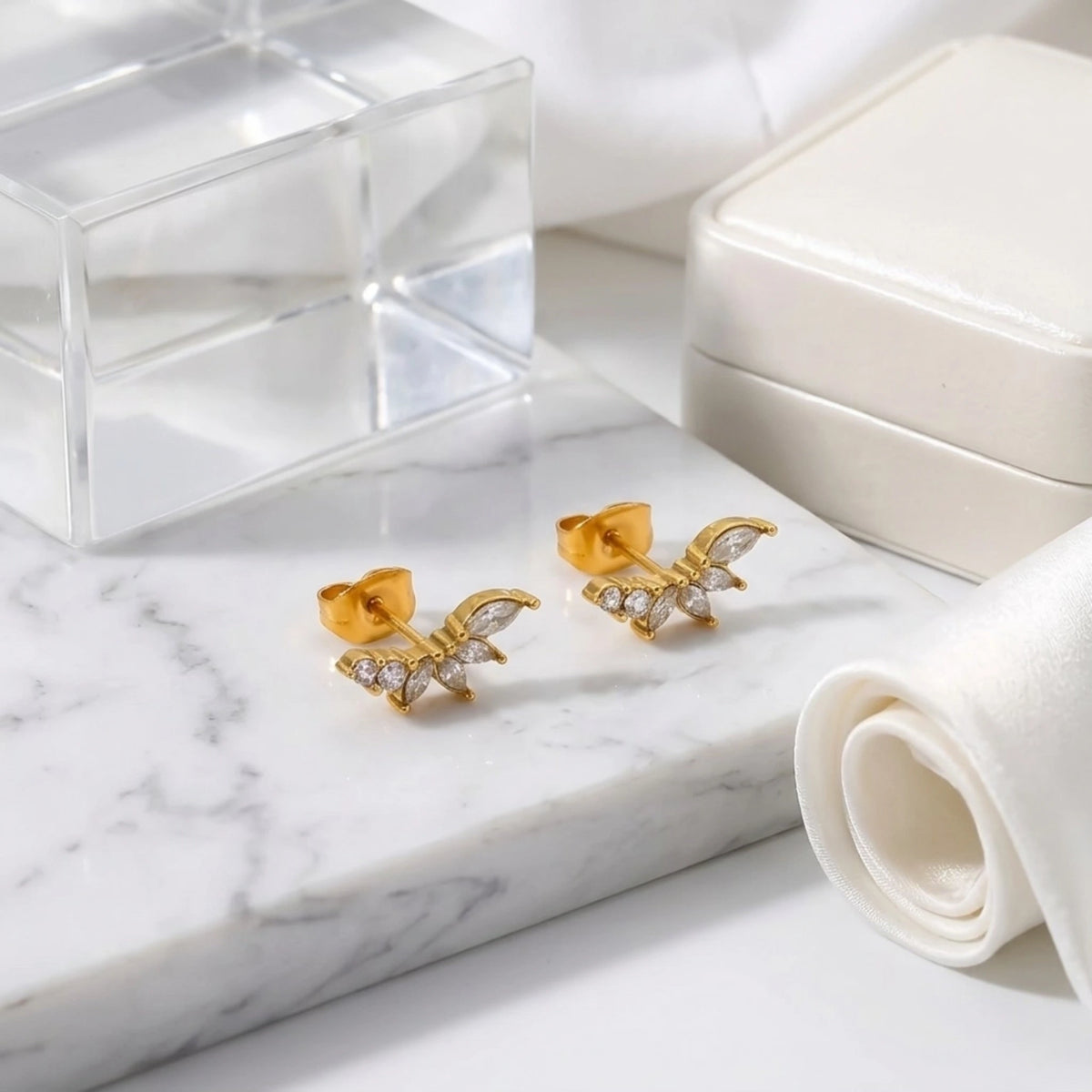 BEHI MILANO Josa Earrings — 18k gold crystal cluster studs on marble display tray