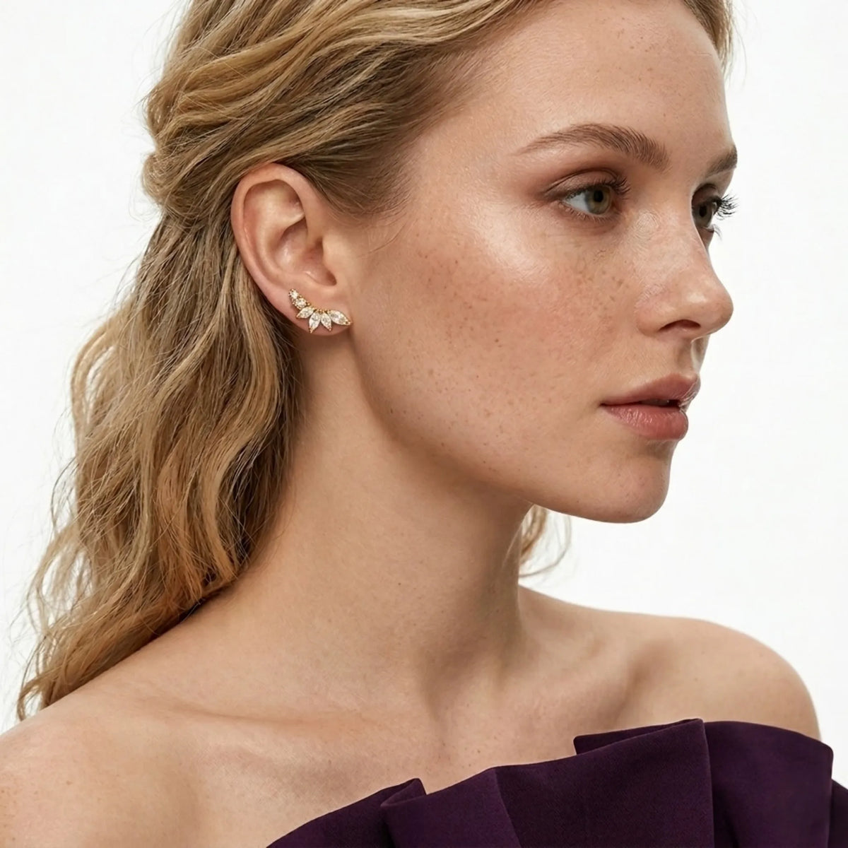BEHI MILANO Josa Earrings — model wearing gold floral crystal ear crawler stud earrings