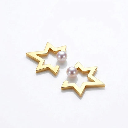 BEHI MILANO Kaia Earrings — gold star outline studs with pearl center on white display block