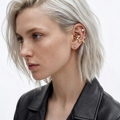 BEHI MILANO Kaia Earrings — close up of platinum blonde model displaying gold star pearl stud on ear