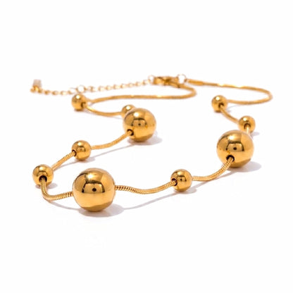 BEHI MILANO Kassia Necklace — studio display layout of 18k gold snake chain with spherical beads