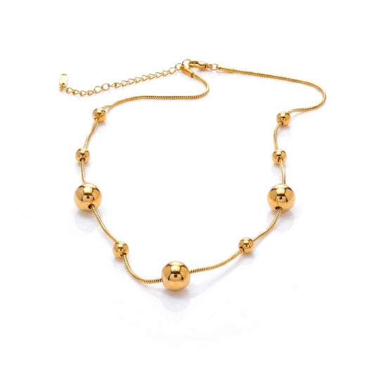 BEHI MILANO Kassia Necklace — 18k gold-plated snake chain choker with gold sphere beads on white background