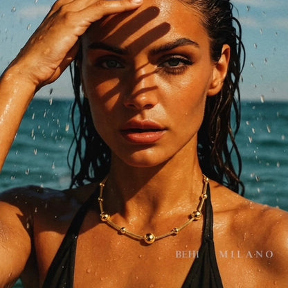 BEHI MILANO Kassia Necklace — close up portrait of wet hair model wearing gold bead choker in sea water