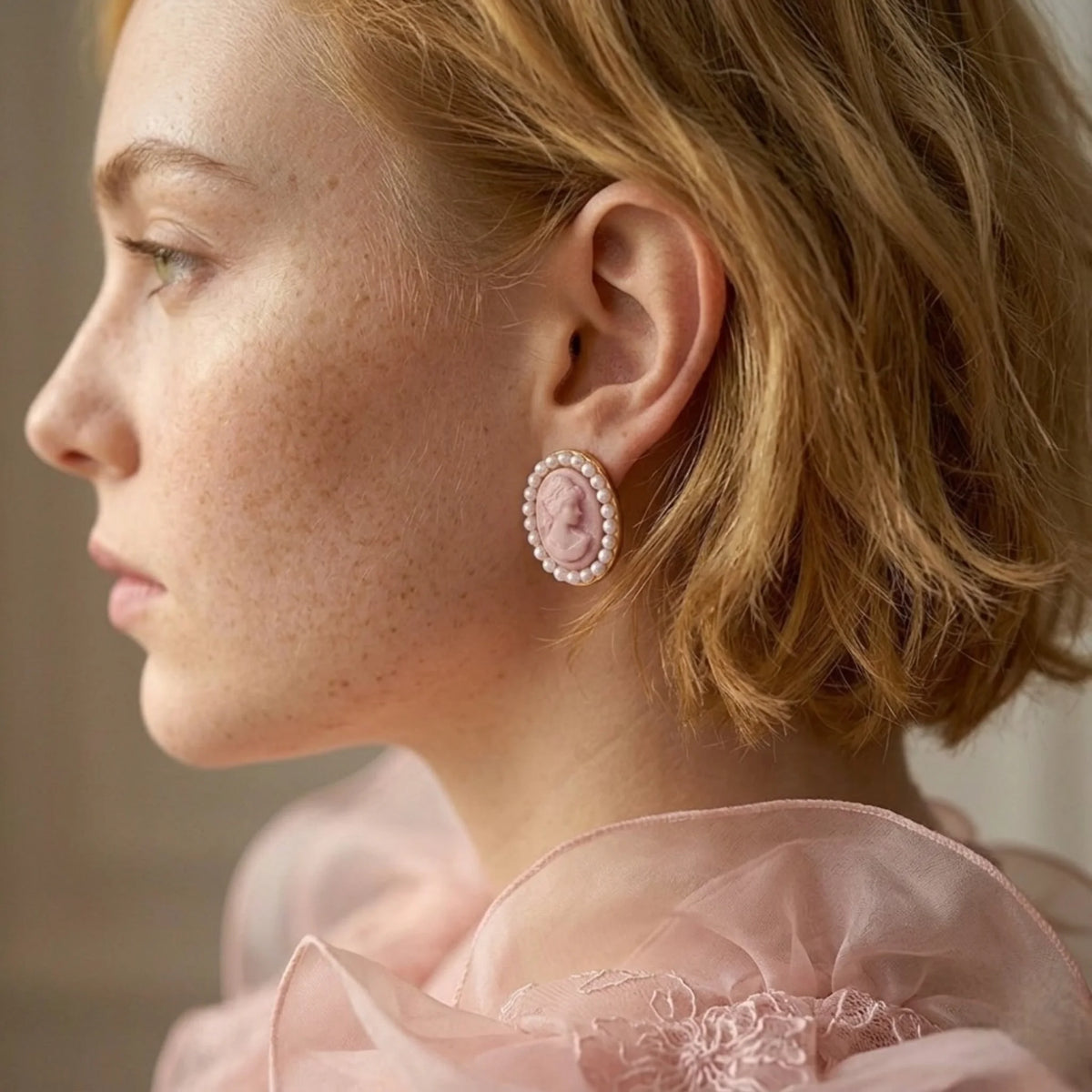 BEHI MILANO Lady Earrings — side profile of model with short blonde hair wearing pink cameo pearl stud earring