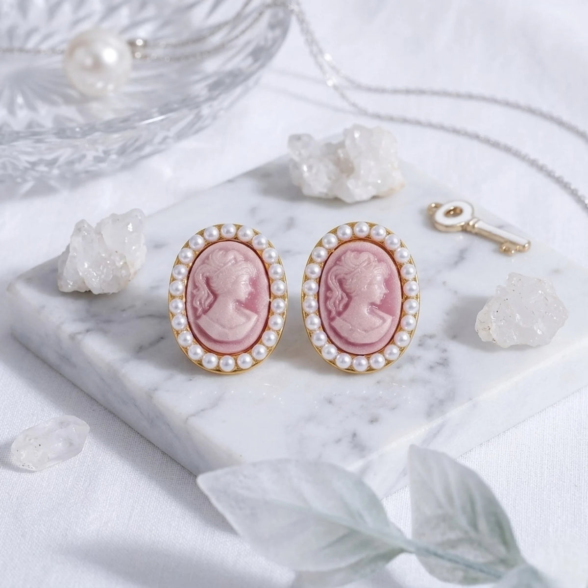 BEHI MILANO Lady Earrings — pair of pink resin cameo gold studs surrounded by loose pearls on white dish