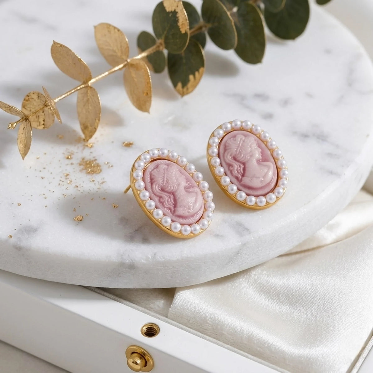 BEHI MILANO Lady Earrings — flat lay display of pink cameo pearl stud earrings on white marble tray with roses