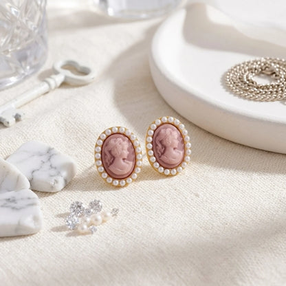 BEHI MILANO Lady Earrings — pair of pink resin cameo gold studs surrounded by loose pearls on white dish