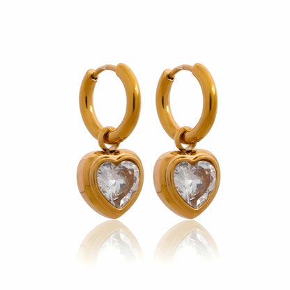 BEHI MILANO Lana Earrings — 18k gold-plated huggie hoop earrings with heart-cut cubic zirconia drops