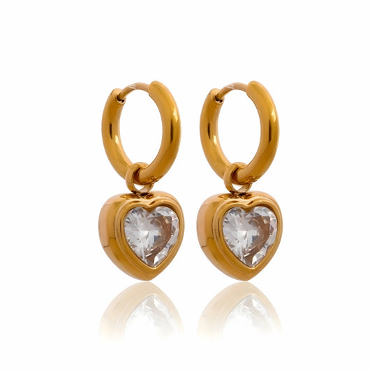 BEHI MILANO Lana Earrings — 18k gold-plated huggie hoop earrings with heart-cut cubic zirconia drops