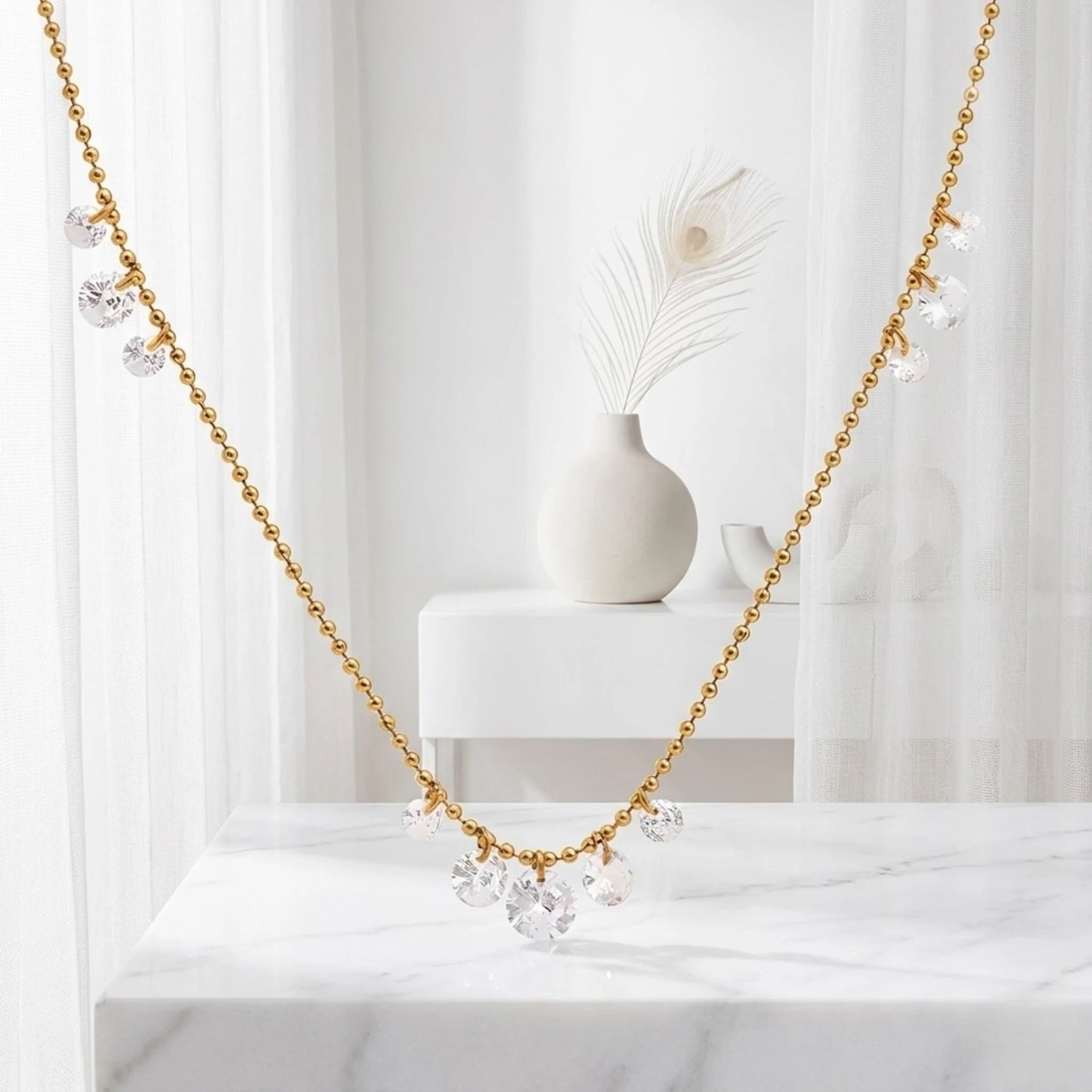 BEHI MILANO Larissa Necklace — delicate gold zircon drop necklace draped in soft white studio window setting