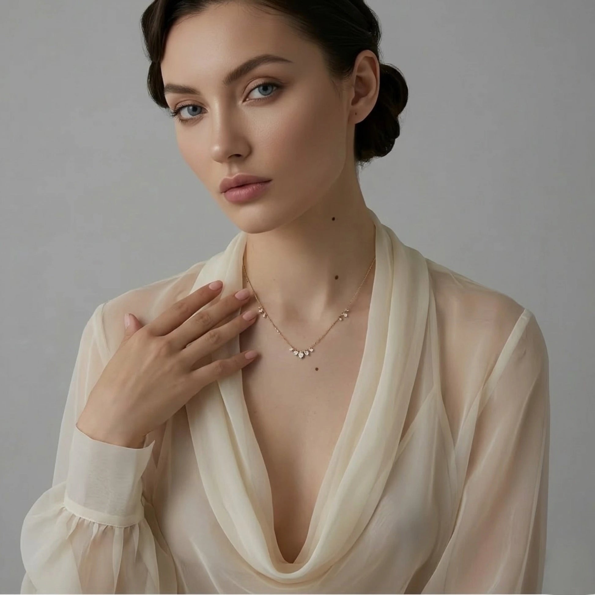 BEHI MILANO Larissa Necklace — model wearing gold zircon drop necklace with plunging beige dress