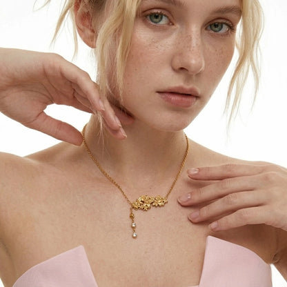 BEHI MILANO Lauris Necklace — model wearing 18k gold floral crystal drop necklace with pink silk dress