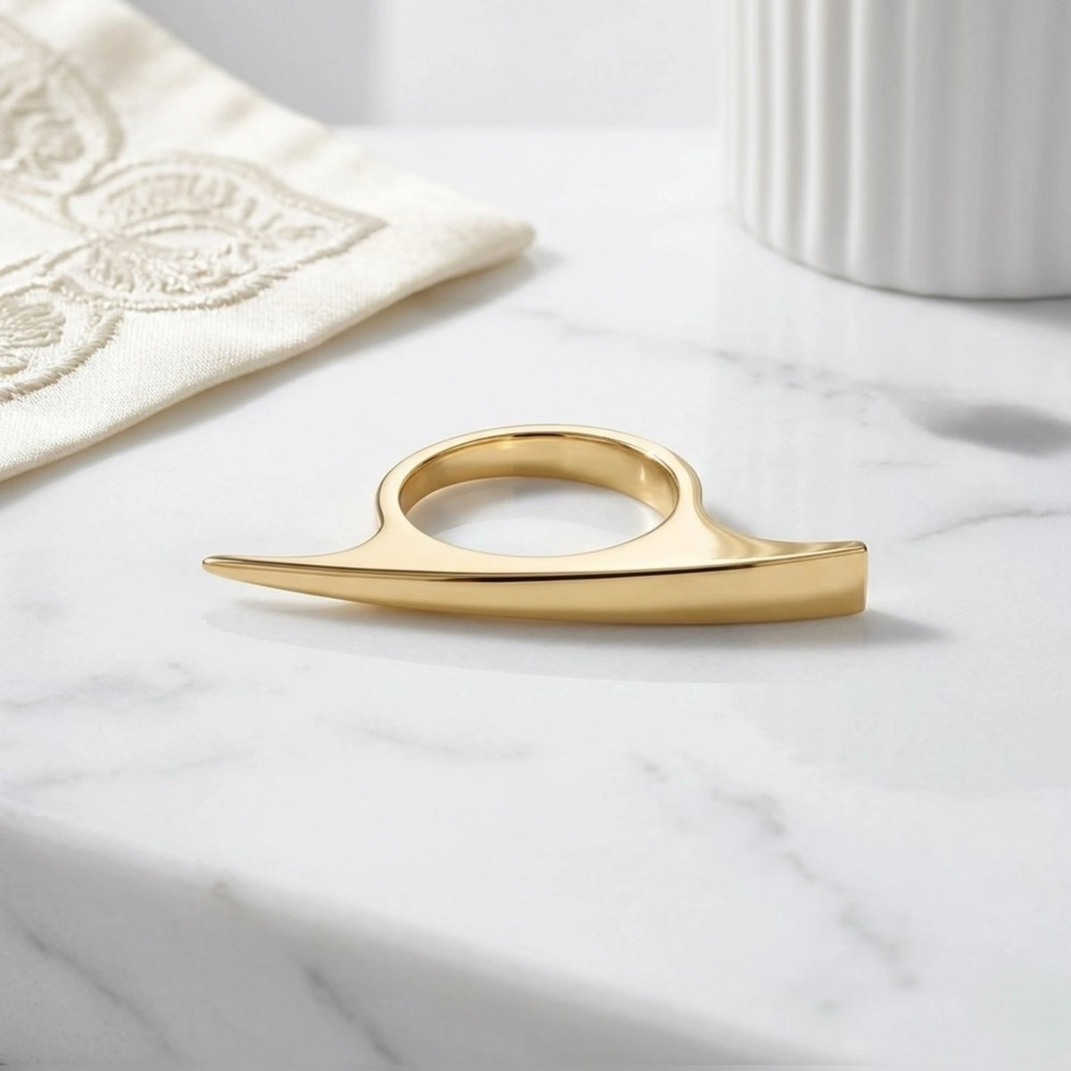 BEHI MILANO Leena Ring — gold sculptural ring displayed on white decorative porcelain tray