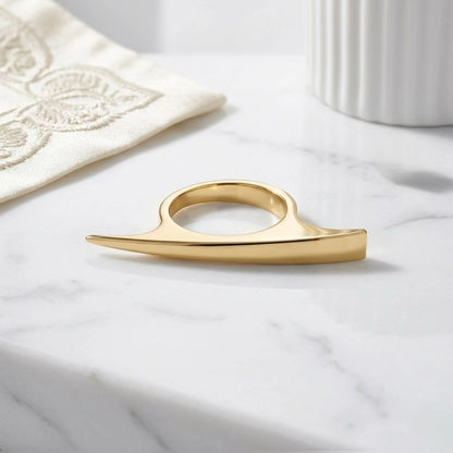BEHI MILANO Leena Ring — gold sculptural ring displayed on white decorative porcelain tray